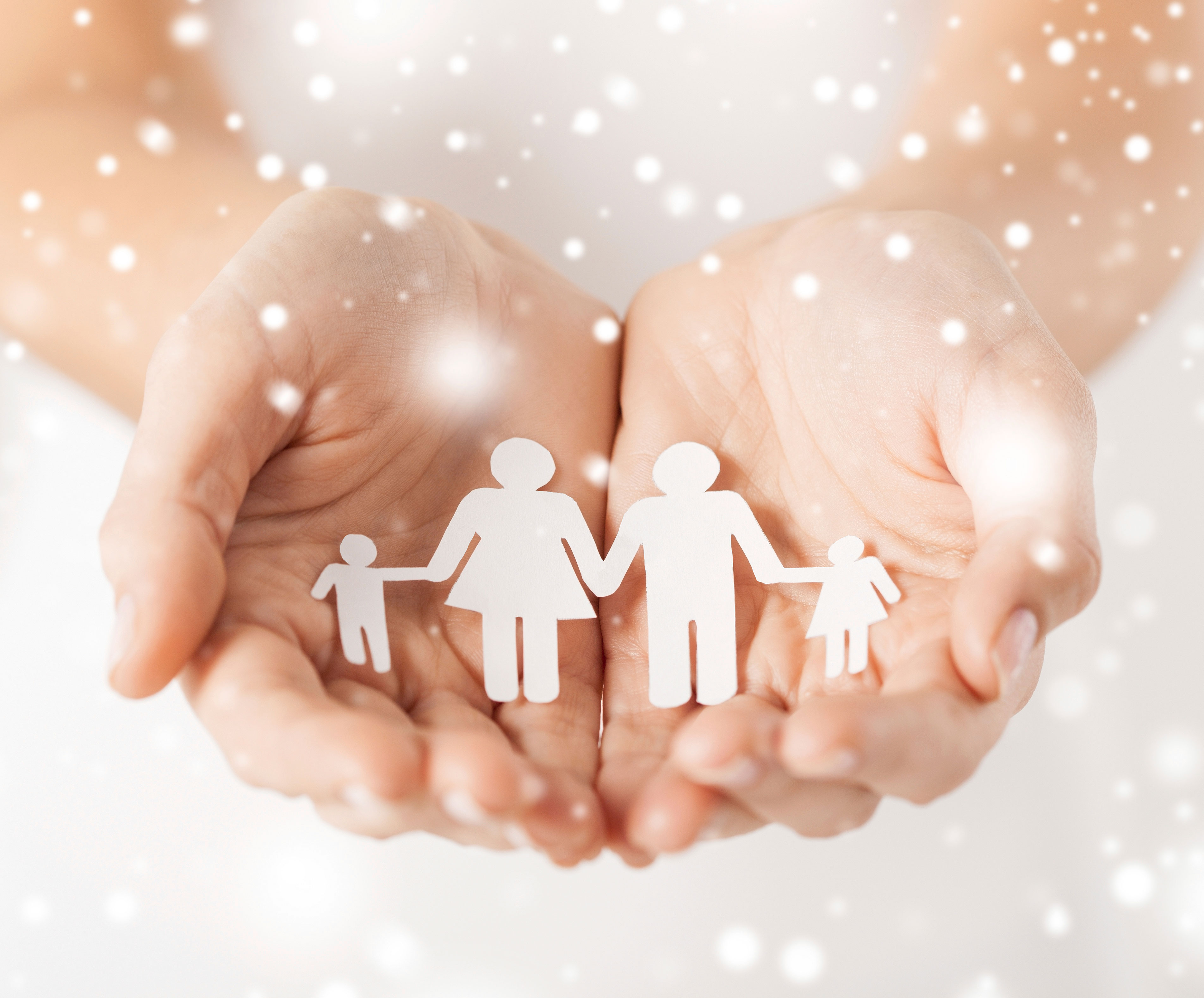 child holding paper cut-out of a family